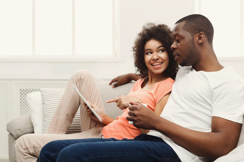 Choosing The Right Solar Package For Your Home A father and a daughter sitting on the couch