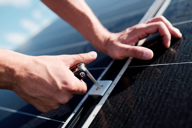 The Importance of Maintaining Your Solar System A man fixing the Solar Panel