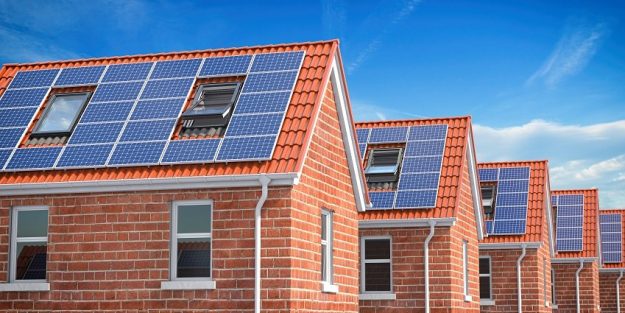 Row of house with solar panels on roof on blue sky background. Row of house with solar panels on roof on blue sky background. 3d illustration
