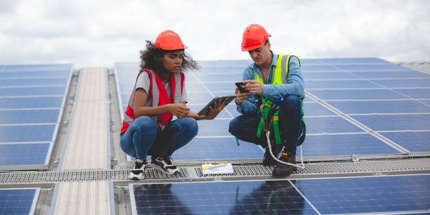 Specialist technician professional engineer checking top view of installing factory solar roof panel